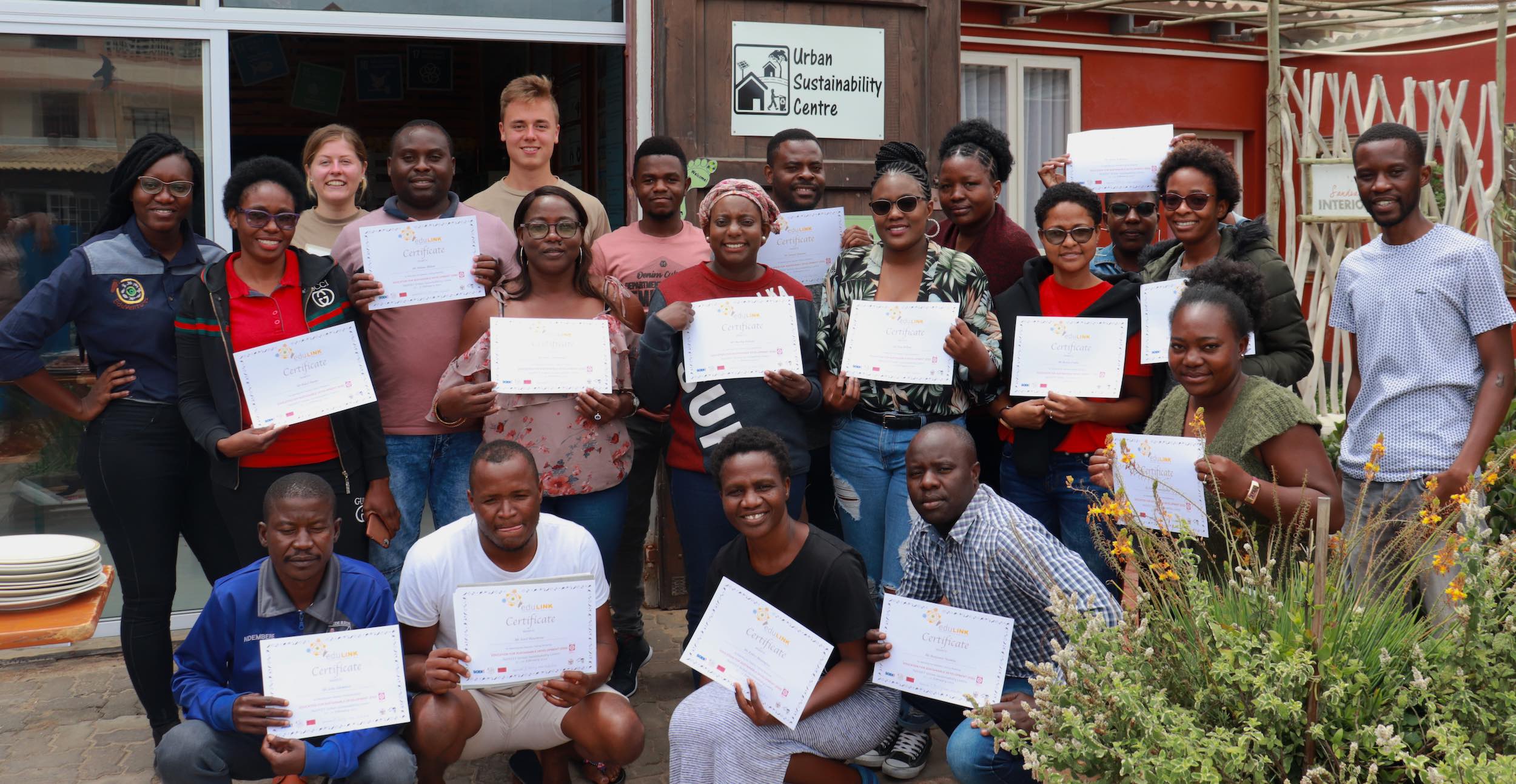 A group shows off their course certificates outside the NaDEET Sustainable Development Centre in Swakopmund.