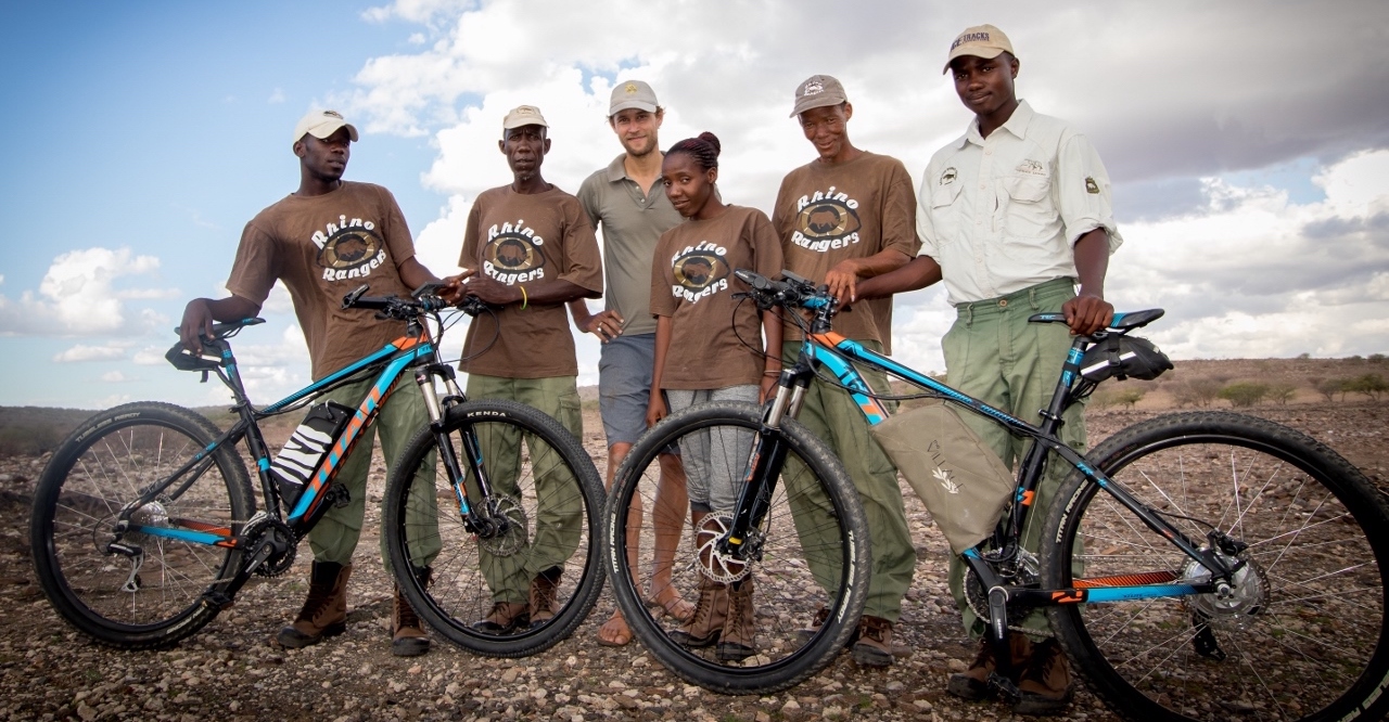A group of Namibian rhino rangers pose with their SunCycles