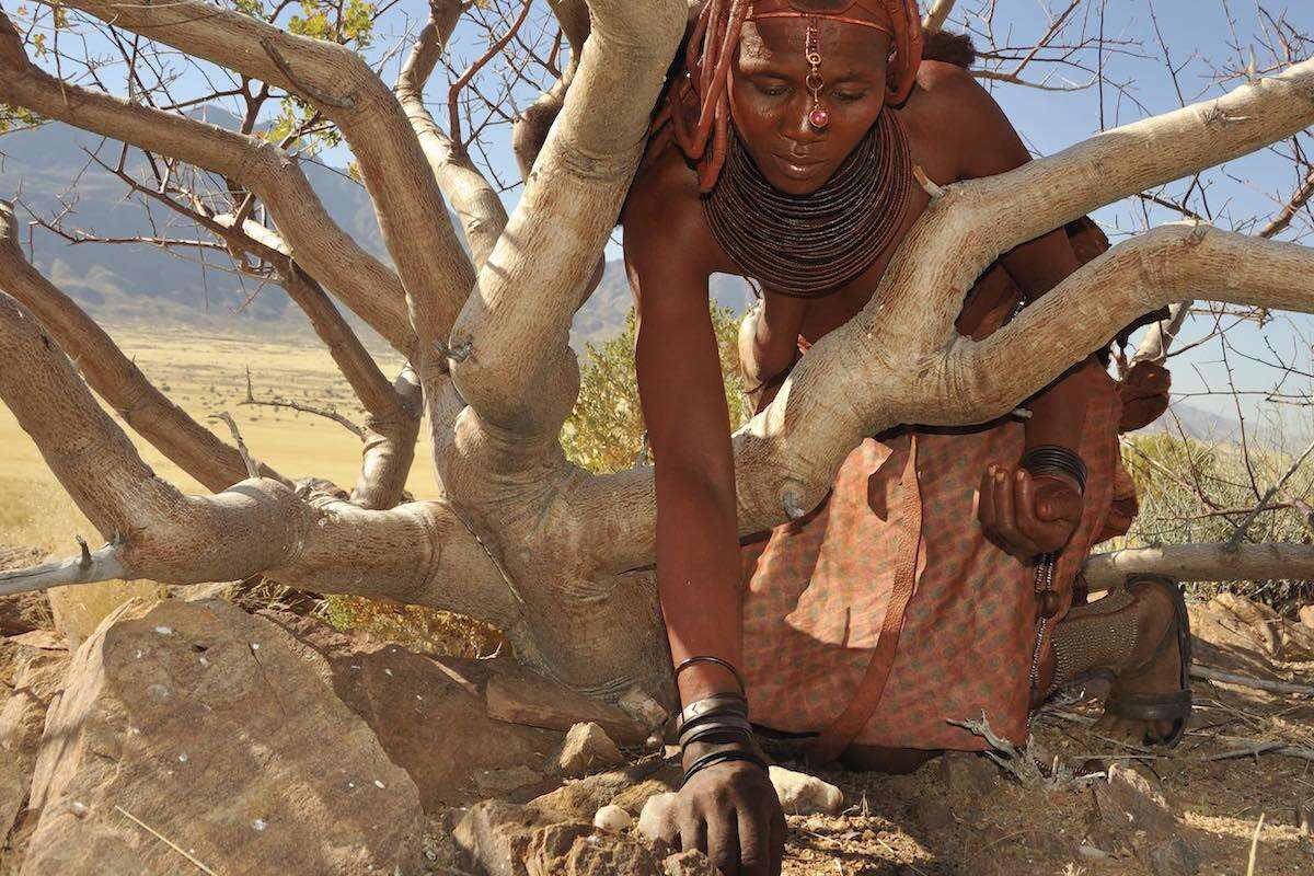 A Himba lady working in the bush.