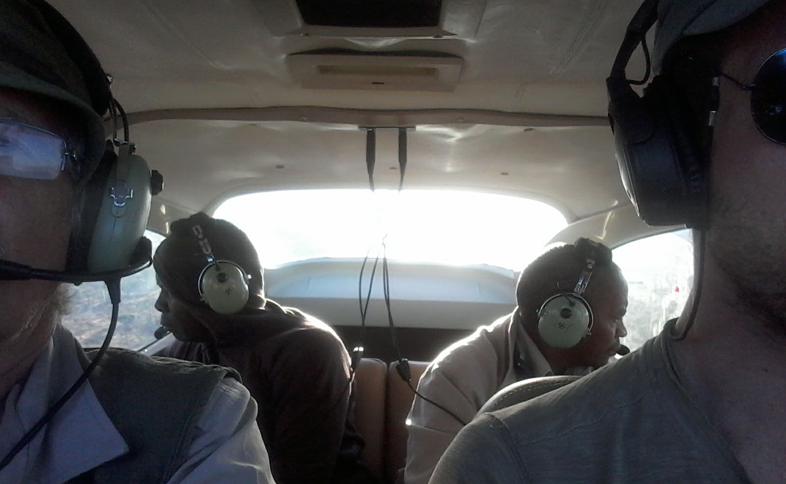 The inside of the four-seat Cessna aircraft, showing the four people involved in the survey.