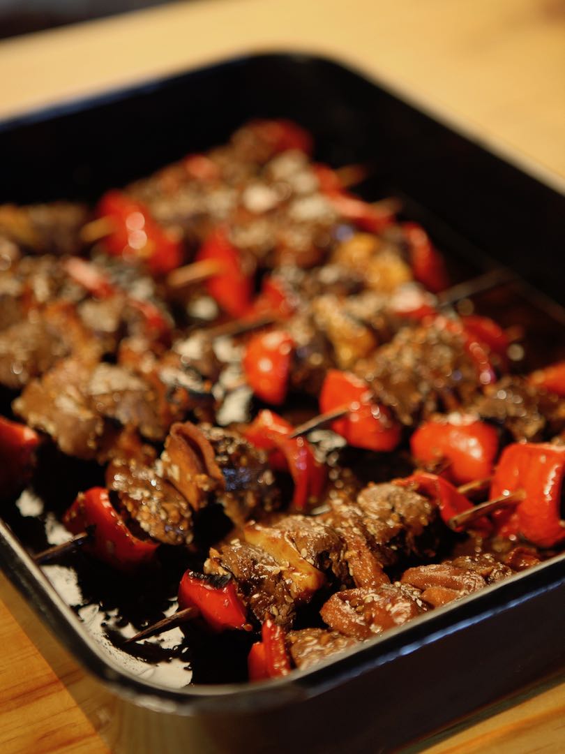 A dish of meat and vegetables on skewers