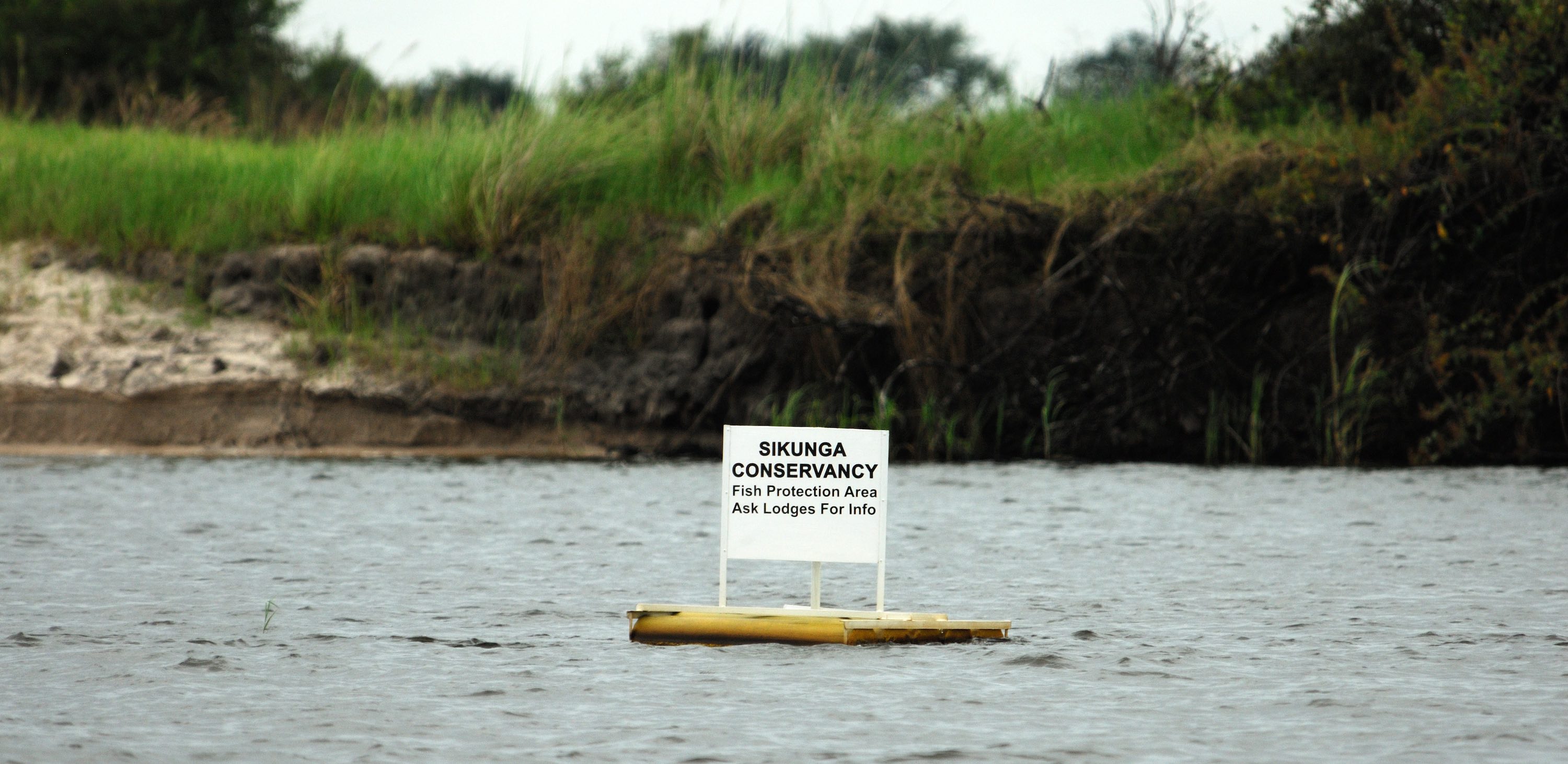 A floating sign informing about fish protection zones.