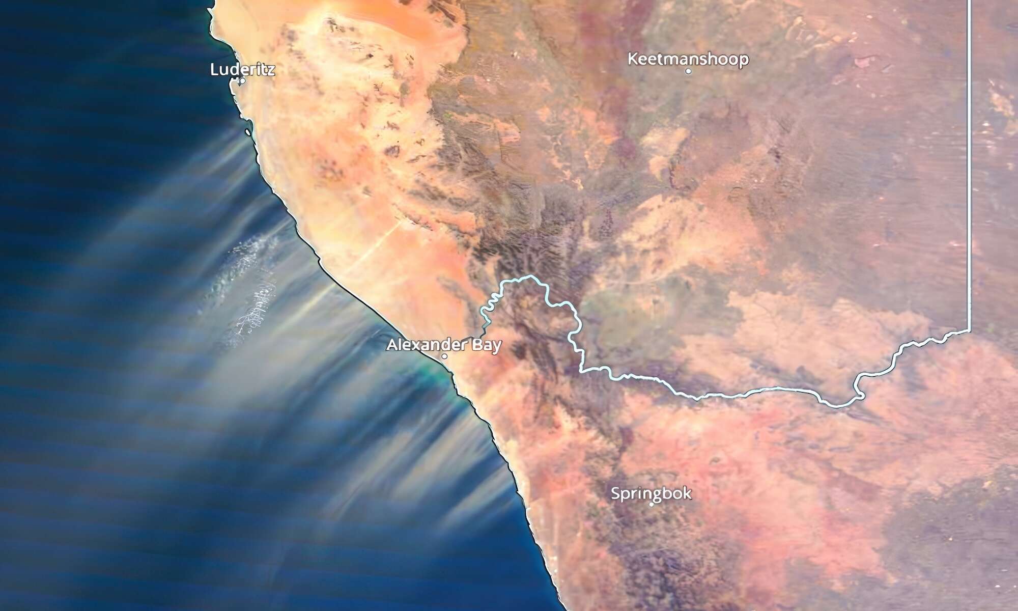 Satellite image showing huge dust streams emmanating from the coast and spreading out across the Atlantic ocean.