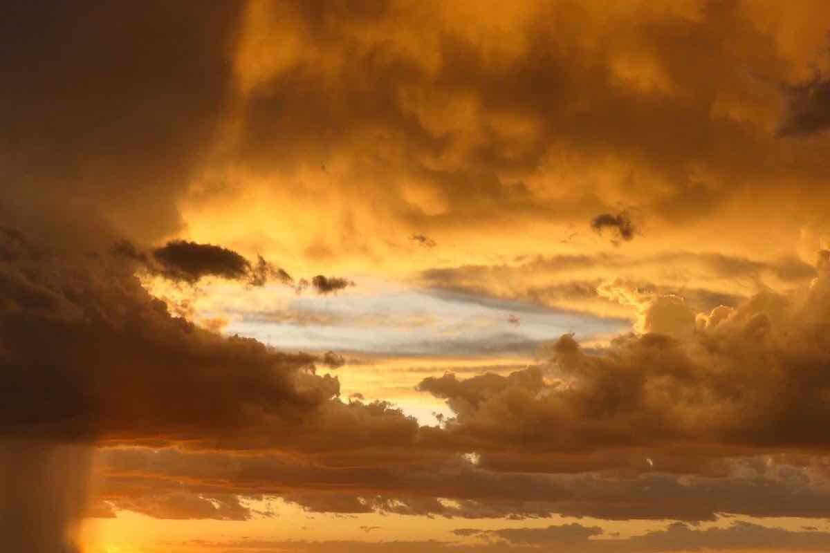 Stunning orange-lit clouds and a rain storm.