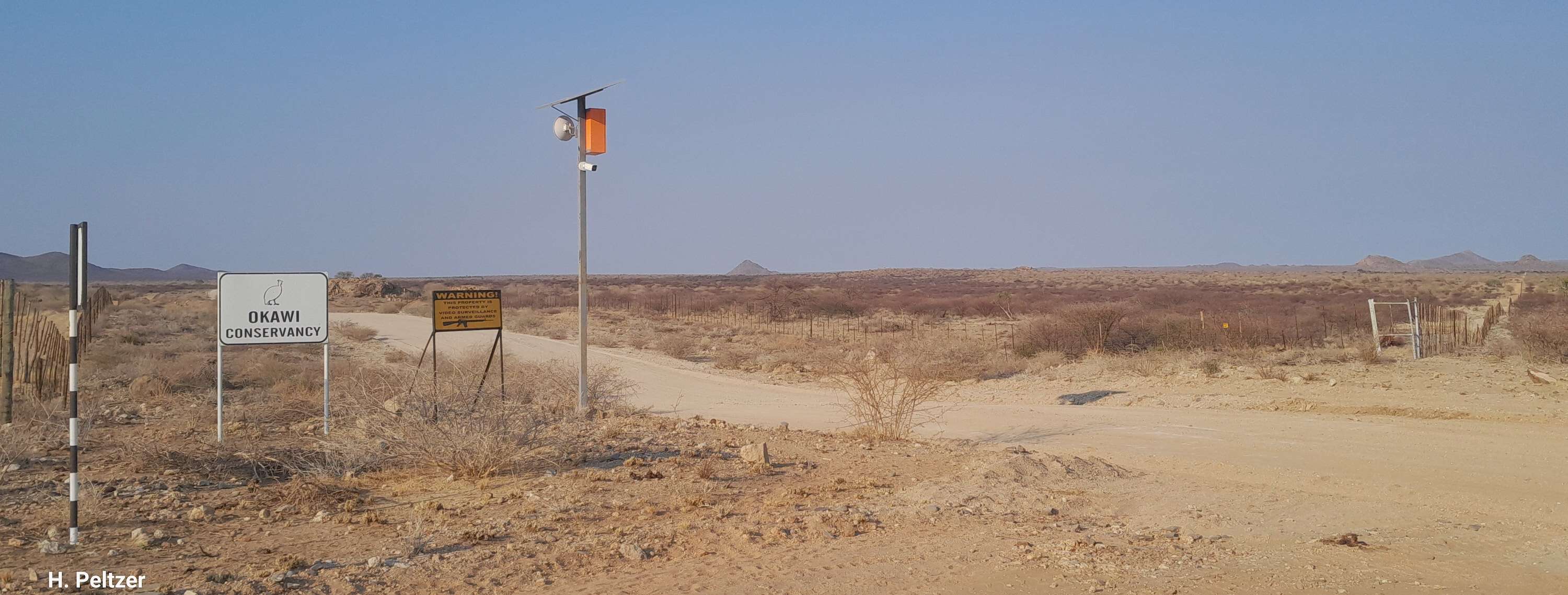 A signpost next to a dusty road.