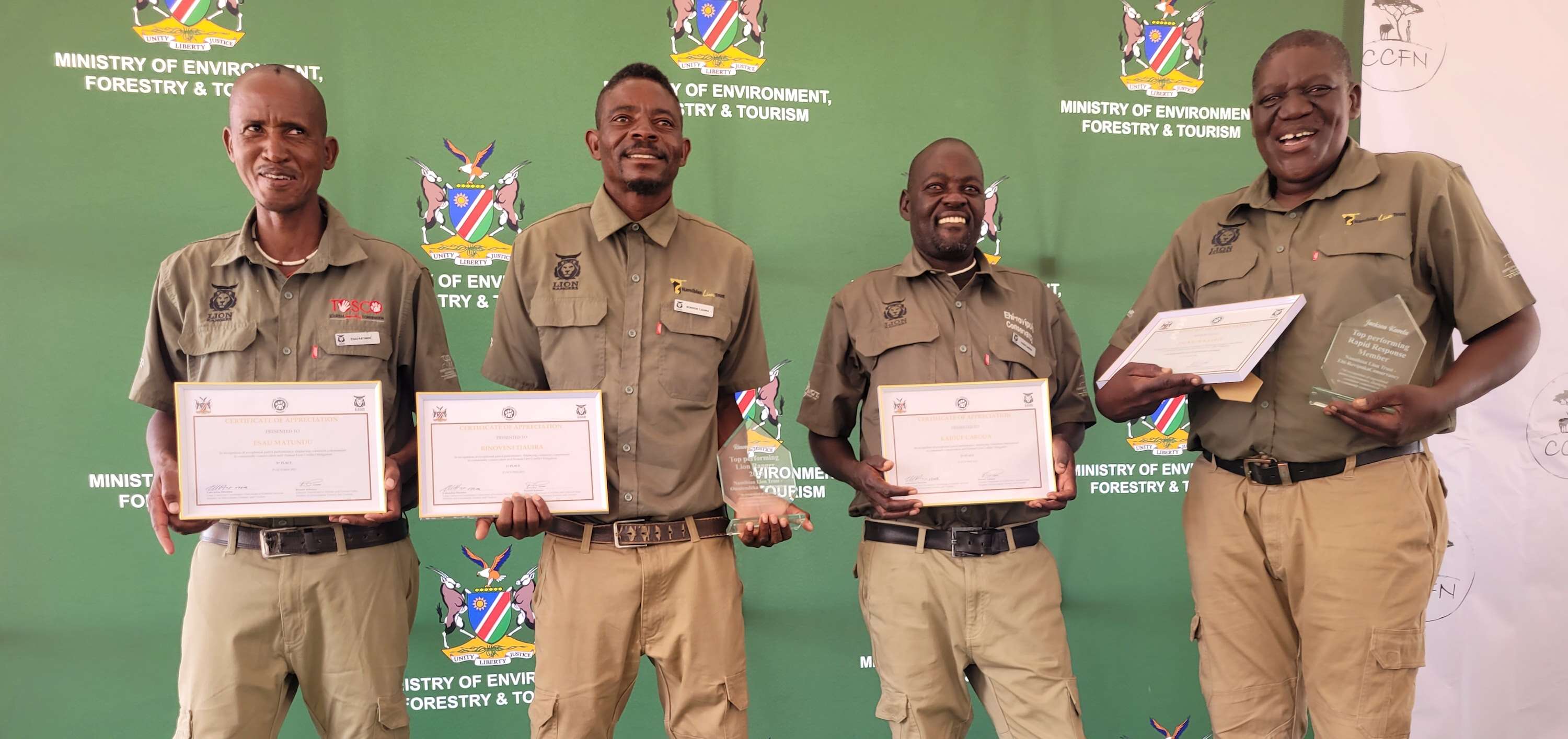 Four rangers post with their award certificates.