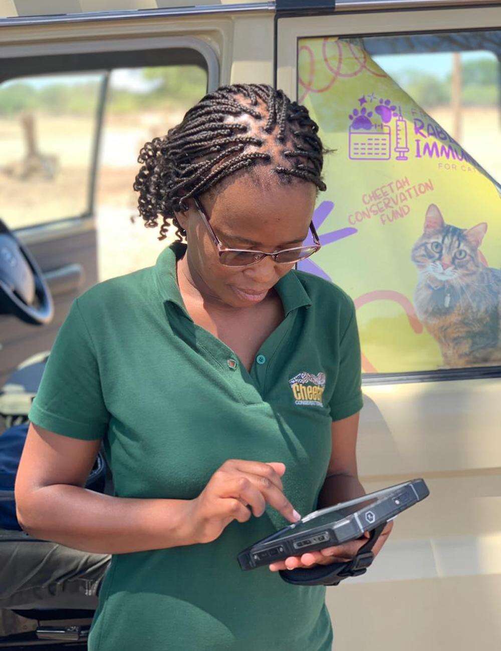 A woman enters data on a tablet.