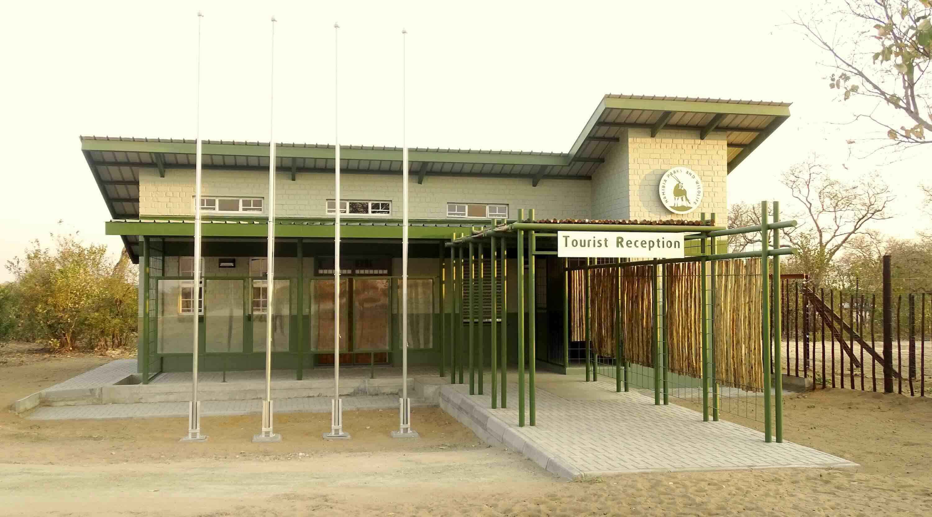 A smart looking brick and metal building with a sign reading: Tourist Reception.