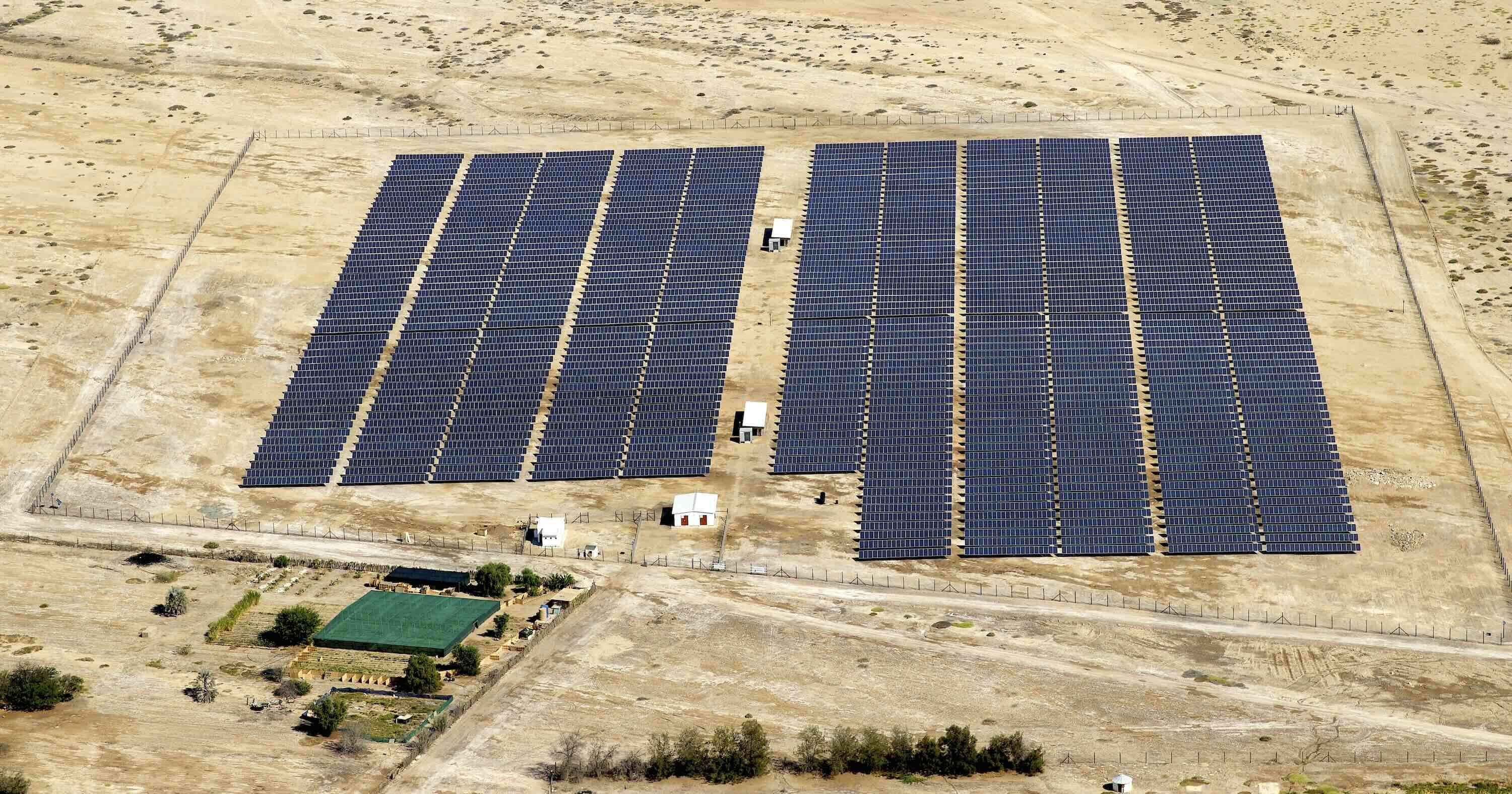 Aerial view of a large solar farm in the desert.