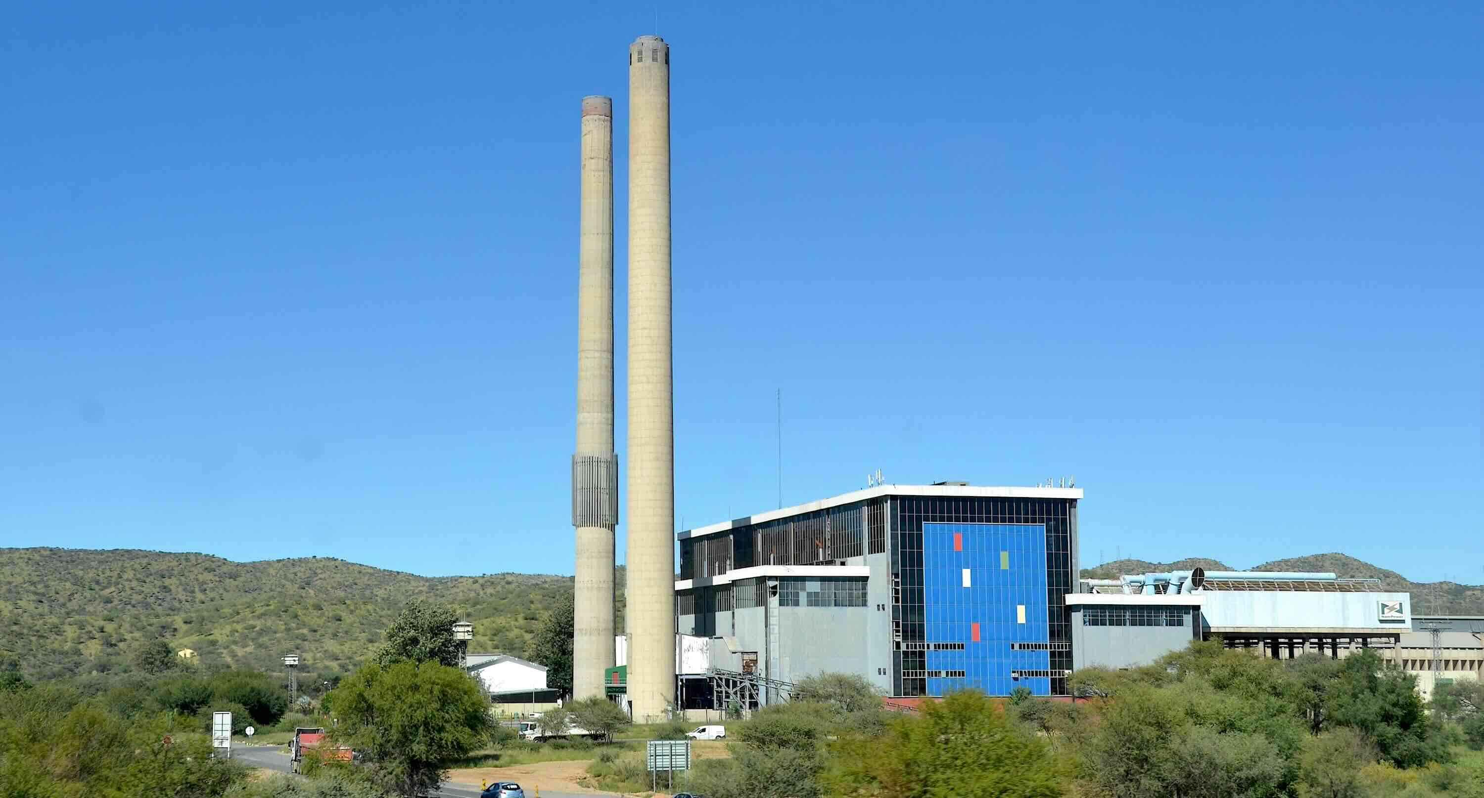 An old power station with two tall chimneys.