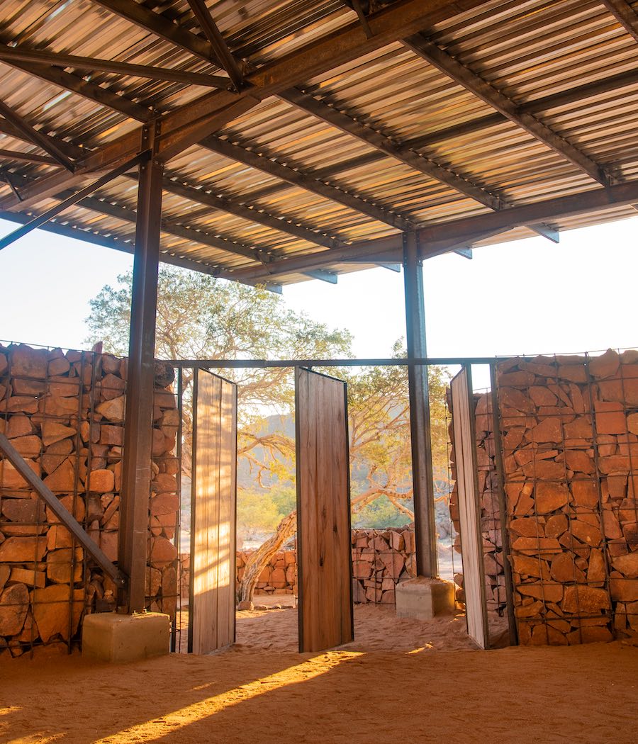 Wooden doors lead into a stone building.