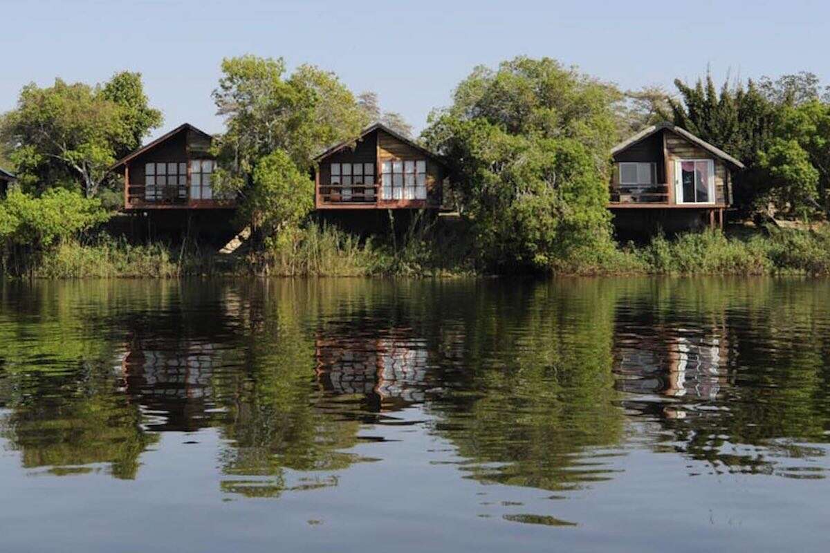 Three luxury chalets overlooking a wide river.