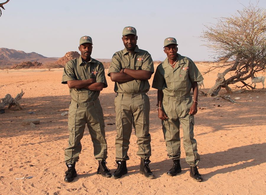 Three community game guards pose in their new uniforms.