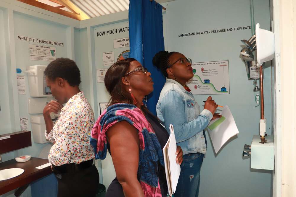 An interior view the NaDEET Urban Sustainability Centre in Swakopmund, with several teachers from Erongo looking at the displays.