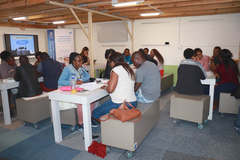 A group of teachers carry out an exercise in on of the centre's classrooms.