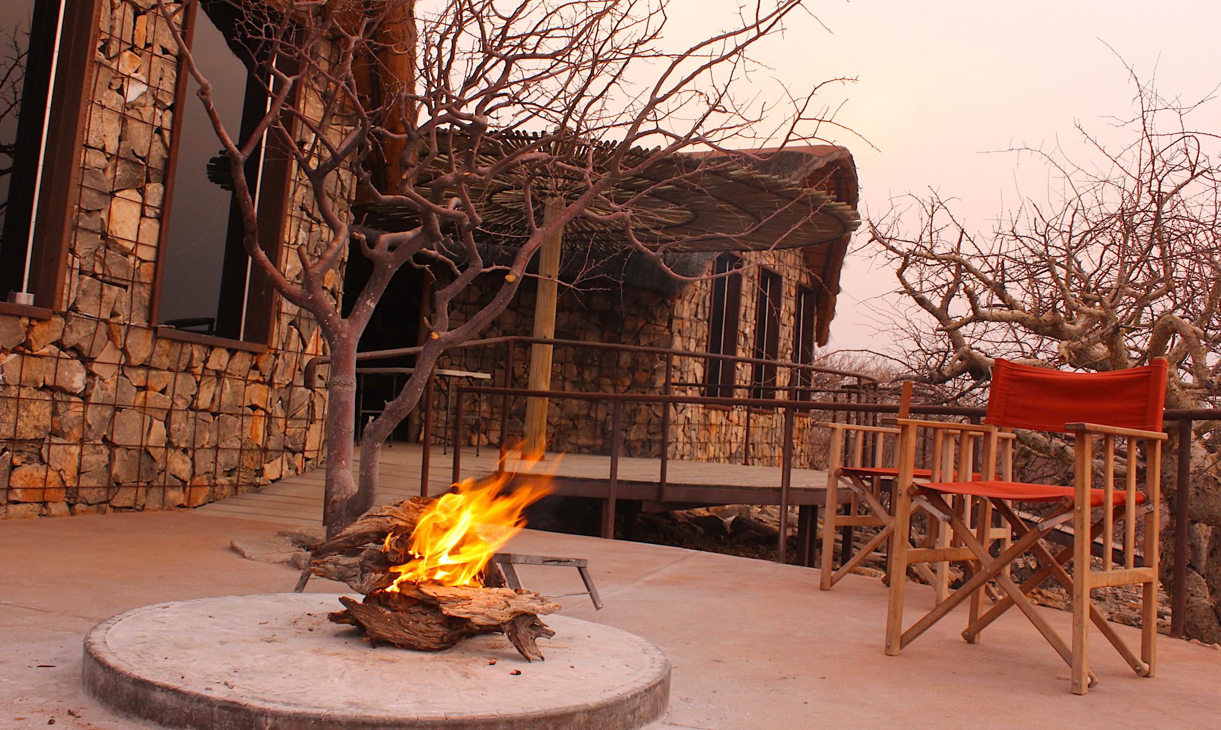 A fire burns in the firepit on the main deck at Etambura lodge in northern Namibia.