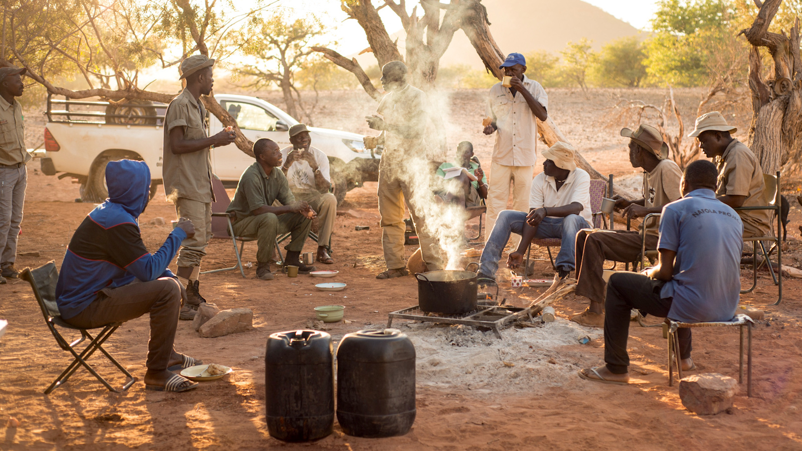 A group of lion rangers relax at one of their field camps.