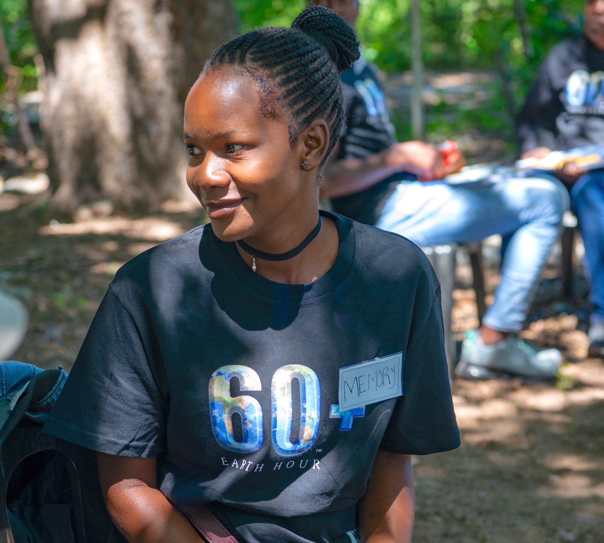 A smiling young woman wearing an Earth Hour t-shirt.