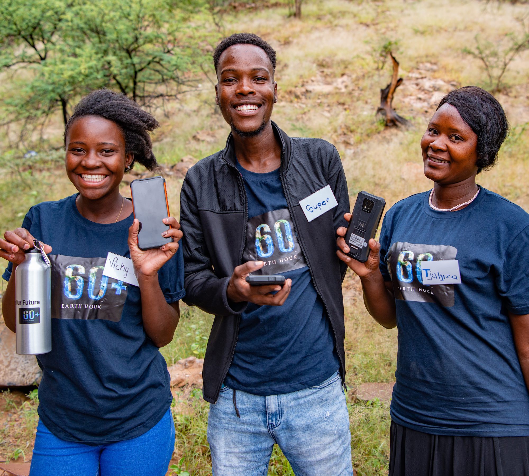 Three young Namibians smile at the camera