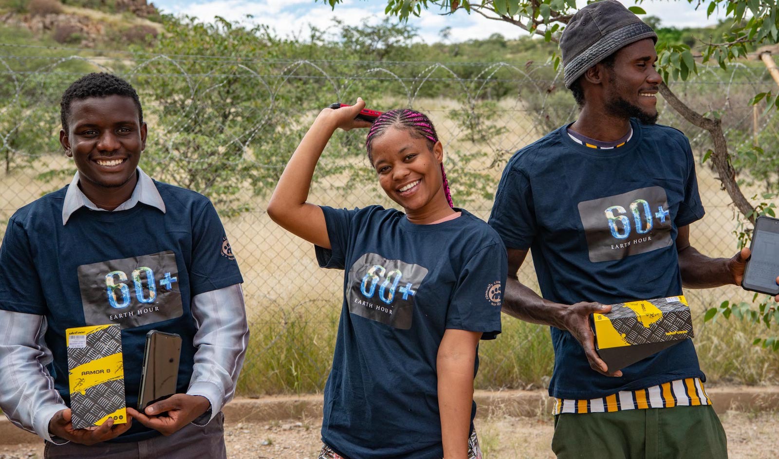 Three young Namibians with the devices they will use with the biodiversity app.